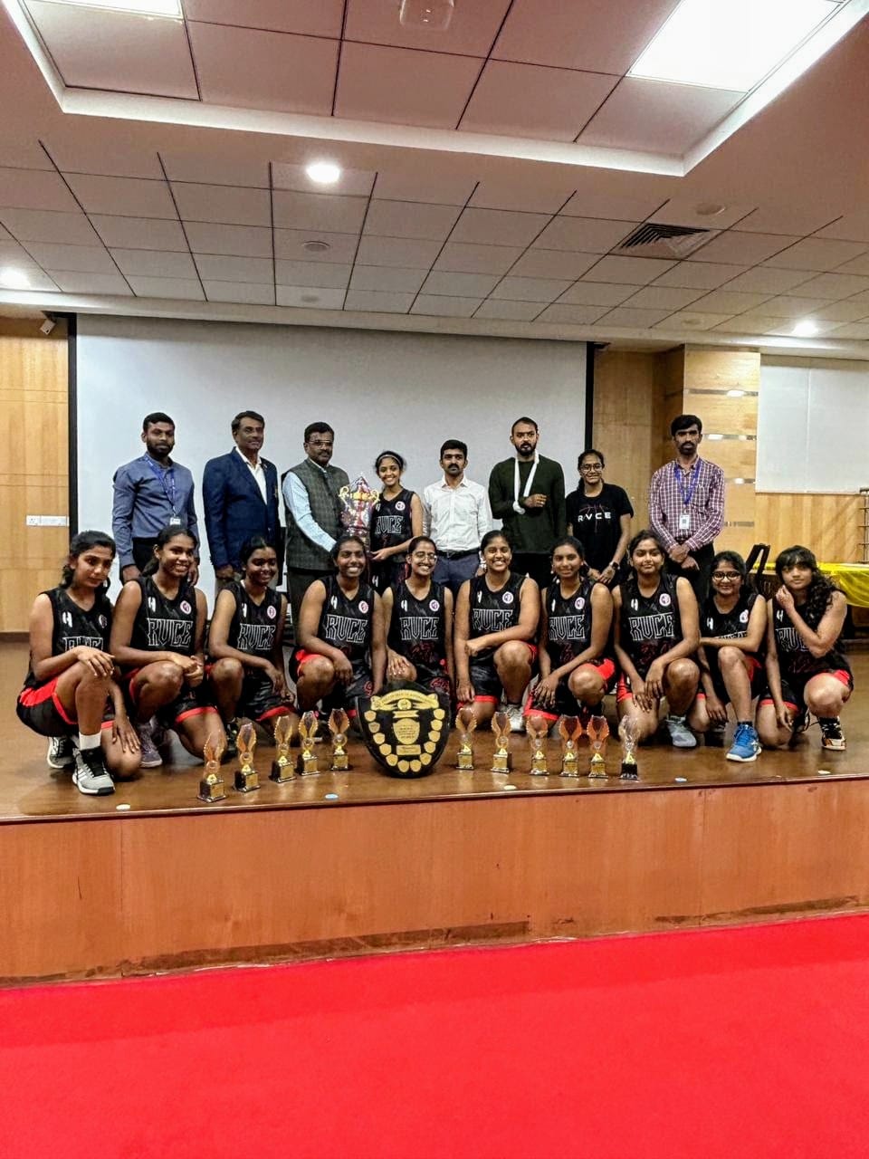 Team felicitated on stage with shield and trophies